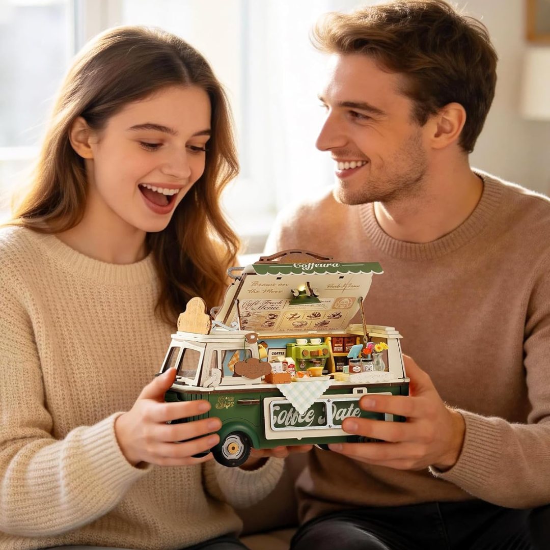 A couple delighted by a handcrafted model camper
