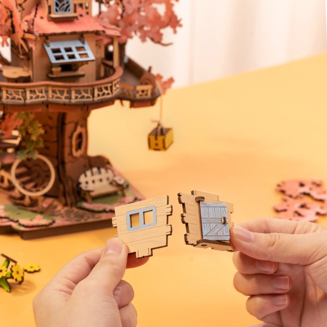 Hands assembling a wooden treehouse puzzle